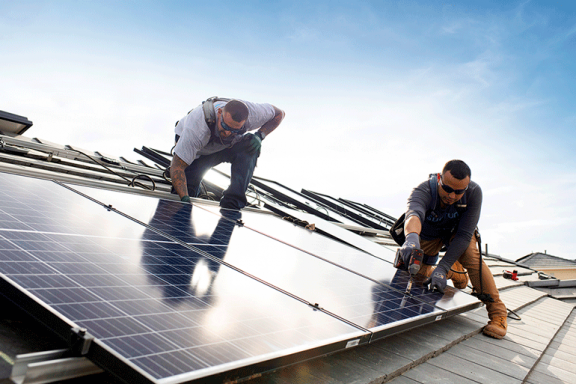 Sunrun solar installers mounting a solar array on a roof with a drill