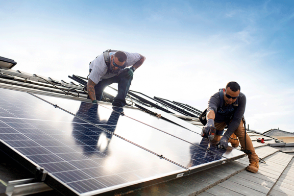 Sunrun solar installers mounting solar panels on roof with a drill