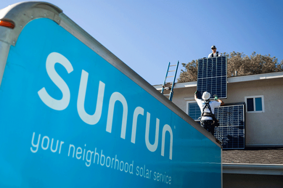 Sunrun solar installers moving solar panels from the back of a Sunrun truck