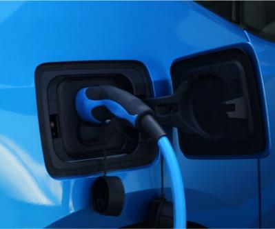 EV charger plugged into electric blue car