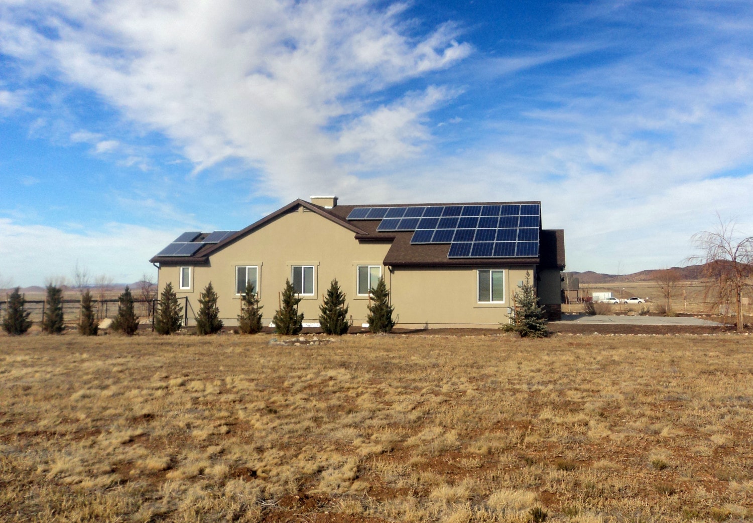house in desert with solar panels