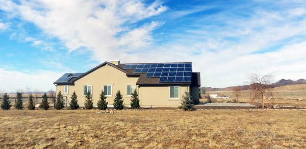 Home with rooftop solar panels in a dry environment