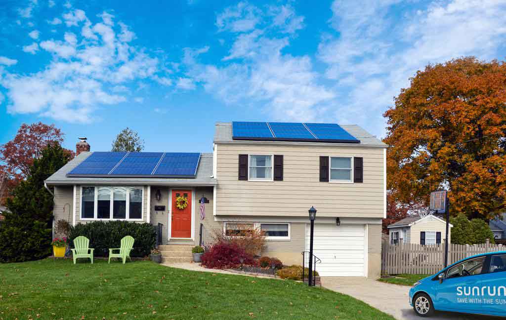 A Man Holding a Drill, Installing Solar Panels in the Roof