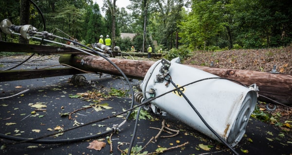 fallen power line with work crew in the background