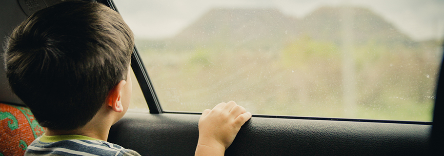 Kid looking out of the car window