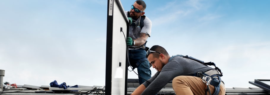 solar installers on roof installing solar panel