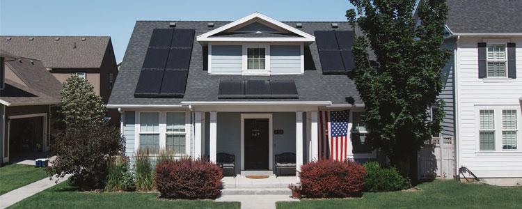 Solar panels on an American house displaying the American flag